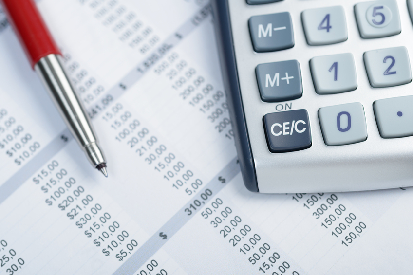 Checking a spreadsheet. Financial calculations using a pen and a portable calculator